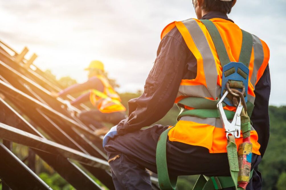 A roofing contractor working with safety equipment in a construction background near Nicholasville, Kentucky (KY)