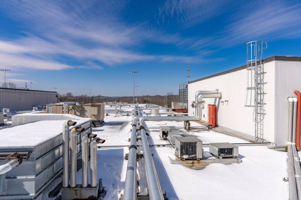 Roof exhaust ventilation and piping equipment on a snow covered commercial building near Nicholasville, Kentucky (KY)